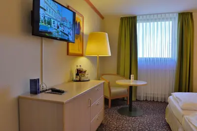Ein Bett oder Betten in einem Zimmer der Unterkunft PLAZA INN Leonberg