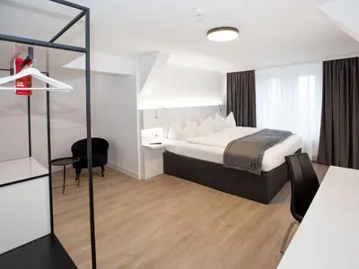 Ein Bett oder Betten in einem Zimmer der Unterkunft DORMERO Hotel Worms
