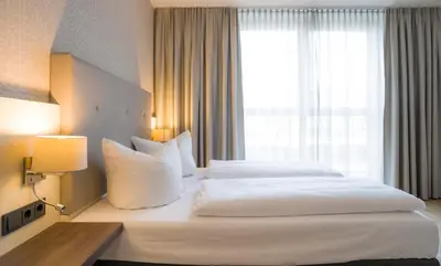 Ein Bett oder Betten in einem Zimmer der Unterkunft Heidelberg Hospitality Boarding House
