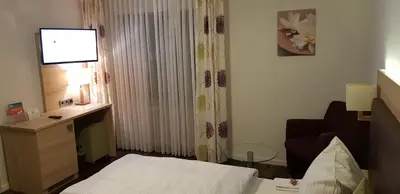 Ein Bett oder Betten in einem Zimmer der Unterkunft Hotel-Restaurant Fröhlich