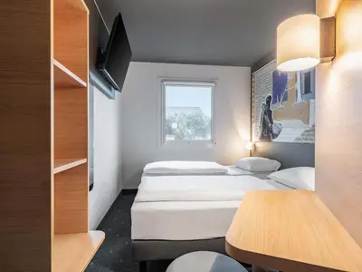 Ein Bett oder Betten in einem Zimmer der Unterkunft B&B HOTEL Mainz-Süd