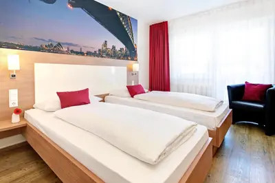 Ein Bett oder Betten in einem Zimmer der Unterkunft Ambassador TheContinents