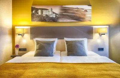 Ein Bett oder Betten in einem Zimmer der Unterkunft Leonardo Hotel Heidelberg Walldorf