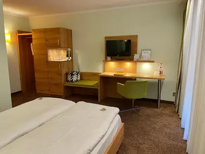 Ein Bett oder Betten in einem Zimmer der Unterkunft Ringhotel Mönch`s Waldhotel
