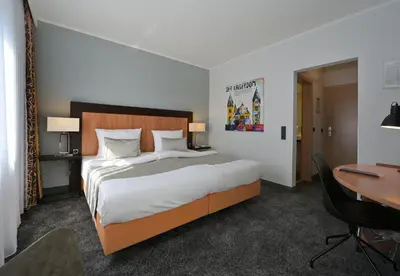 Ein Bett oder Betten in einem Zimmer der Unterkunft Hotel & Living Am Wartturm