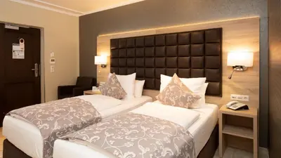 Ein Bett oder Betten in einem Zimmer der Unterkunft Hotel-Restaurant Barbarossahof