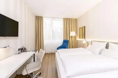 Ein Bett oder Betten in einem Zimmer der Unterkunft NH Weinheim