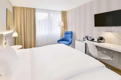Ein Bett oder Betten in einem Zimmer der Unterkunft NH Weinheim