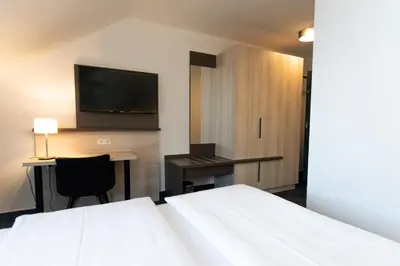 Ein Bett oder Betten in einem Zimmer der Unterkunft Taste Smart Hotel Lampertheim