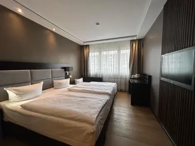 Ein Bett oder Betten in einem Zimmer der Unterkunft Hotel am Karlstor