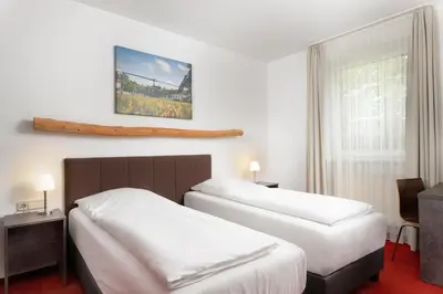 Ein Bett oder Betten in einem Zimmer der Unterkunft Hotel Speyer am Technik Museum