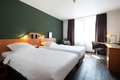 Ein Bett oder Betten in einem Zimmer der Unterkunft ACHAT Hotel Heppenheim