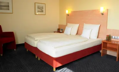 Ein Bett oder Betten in einem Zimmer der Unterkunft Adler Hotel & Restaurant Groß-Gerau