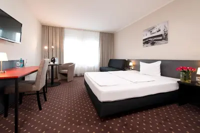Ein Bett oder Betten in einem Zimmer der Unterkunft ACHAT Hotel Hockenheim
