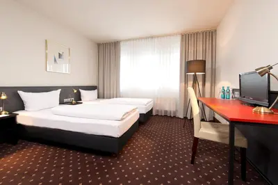 Ein Bett oder Betten in einem Zimmer der Unterkunft ACHAT Hotel Hockenheim