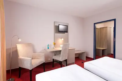 Ein Bett oder Betten in einem Zimmer der Unterkunft ACHAT Hotel Frankenthal in der Pfalz