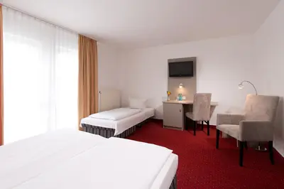Ein Bett oder Betten in einem Zimmer der Unterkunft ACHAT Hotel Frankenthal in der Pfalz