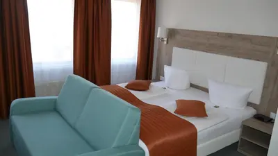 Ein Bett oder Betten in einem Zimmer der Unterkunft Komfort Hotel Ludwigsburg