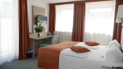 Ein Bett oder Betten in einem Zimmer der Unterkunft Komfort Hotel Ludwigsburg
