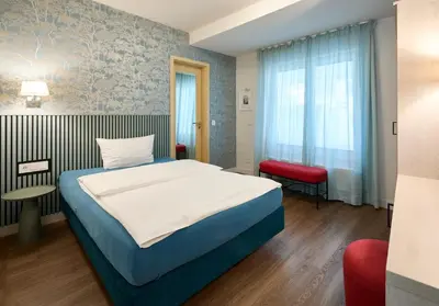 Ein Bett oder Betten in einem Zimmer der Unterkunft Stadthotel