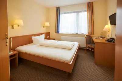 Ein Bett oder Betten in einem Zimmer der Unterkunft Flair Hotel Landgasthof Roger