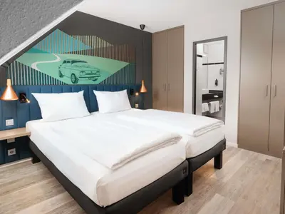 Ein Bett oder Betten in einem Zimmer der Unterkunft ibis Styles Neckarsulm