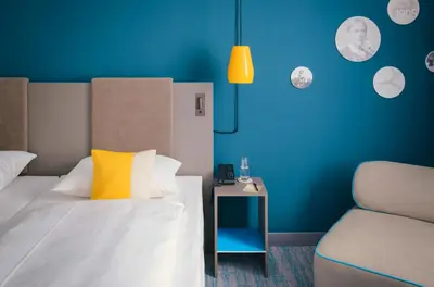 Ein Bett oder Betten in einem Zimmer der Unterkunft Vienna House Easy by Wyndham Neckarsulm