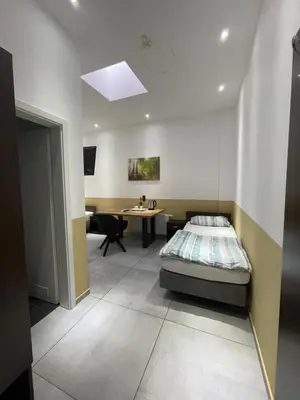 Ein Bett oder Betten in einem Zimmer der Unterkunft Stadtpension Heilbronn