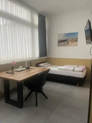 Ein Bett oder Betten in einem Zimmer der Unterkunft Stadtpension Heilbronn