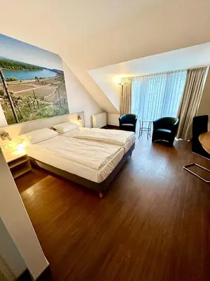 Ein Bett oder Betten in einem Zimmer der Unterkunft Asgard Hotel