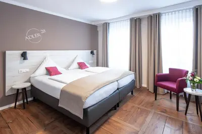 Ein Bett oder Betten in einem Zimmer der Unterkunft Adler Landhotel
