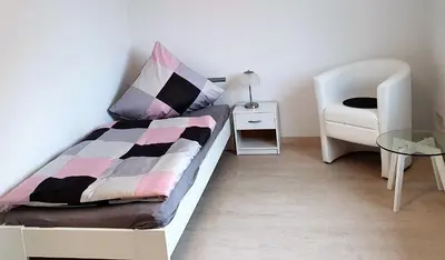 Ein Bett oder Betten in einem Zimmer der Unterkunft Pension Nickel Ferienwohnung II Waldstraße 18 Alsbach-Hähnlein