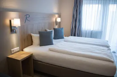 Ein Bett oder Betten in einem Zimmer der Unterkunft Hotel Rosenbusch