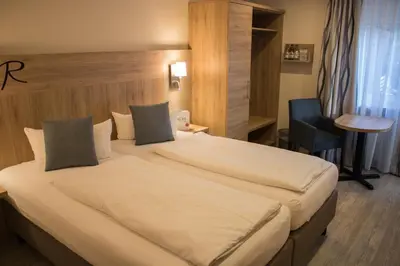 Ein Bett oder Betten in einem Zimmer der Unterkunft Hotel Rosenbusch