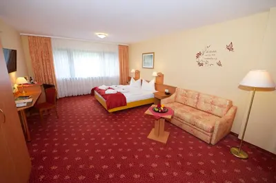 Ein Bett oder Betten in einem Zimmer der Unterkunft Hotel Die Kleine Blume