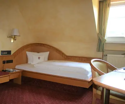 Ein Bett oder Betten in einem Zimmer der Unterkunft Ringhotel Winzerhof