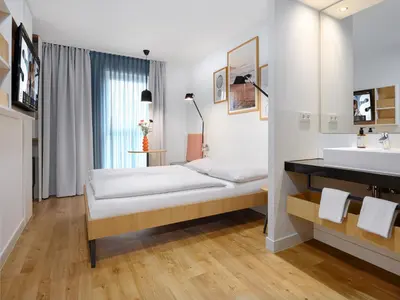 Ein Bett oder Betten in einem Zimmer der Unterkunft smartments Mannheim Hauptbahnhof