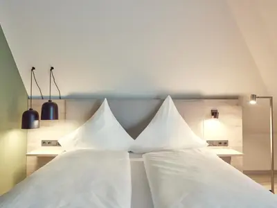 Ein Bett oder Betten in einem Zimmer der Unterkunft Hotel Bad Dürkheim