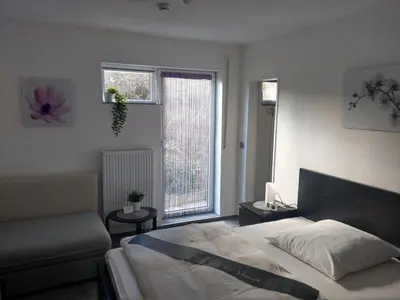 Ein Bett oder Betten in einem Zimmer der Unterkunft Pension Am Waldrand
