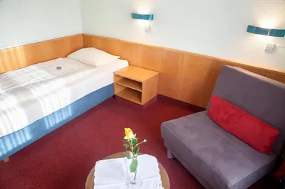 Ein Bett oder Betten in einem Zimmer der Unterkunft Sporthotel Öhringen