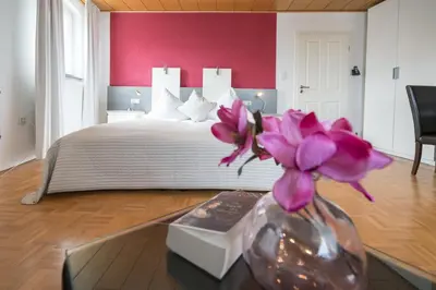 Ein Bett oder Betten in einem Zimmer der Unterkunft Hotel 'Zum Augarten'