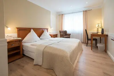 Ein Bett oder Betten in einem Zimmer der Unterkunft Hotel 'Zum Augarten'