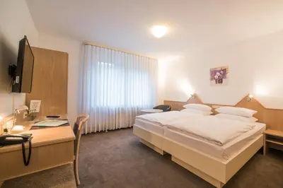 Ein Bett oder Betten in einem Zimmer der Unterkunft Hotel am Wasen