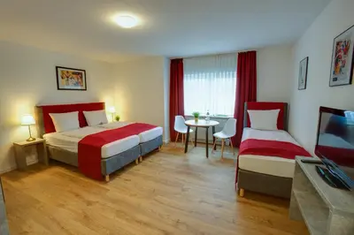 Ein Bett oder Betten in einem Zimmer der Unterkunft Hotel Leo Mühlhausen