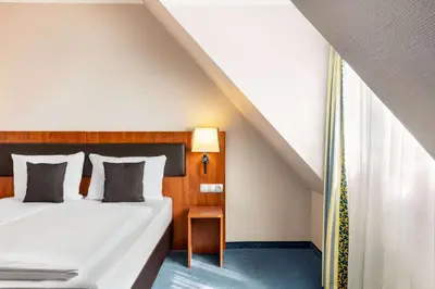 Ein Bett oder Betten in einem Zimmer der Unterkunft Amedia Frankfurt Russelsheim Trademark Collection by Wyndham