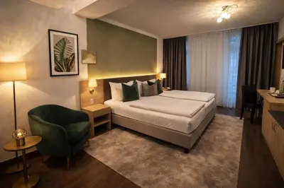 Ein Bett oder Betten in einem Zimmer der Unterkunft Hotel Bayrischer Hof