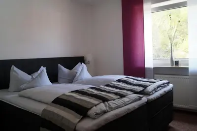 Ein Bett oder Betten in einem Zimmer der Unterkunft Hotel Berg