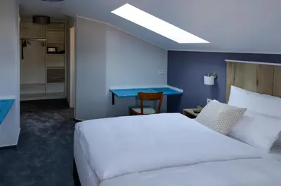 Ein Bett oder Betten in einem Zimmer der Unterkunft Hotel Brasserie Chaussee