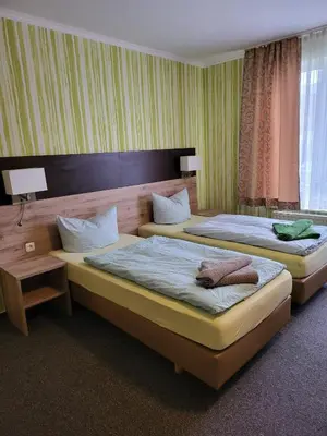 Ein Bett oder Betten in einem Zimmer der Unterkunft Appart Hotel Roßdorf