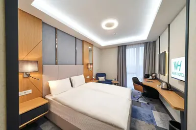 Ein Bett oder Betten in einem Zimmer der Unterkunft WENS Hotel